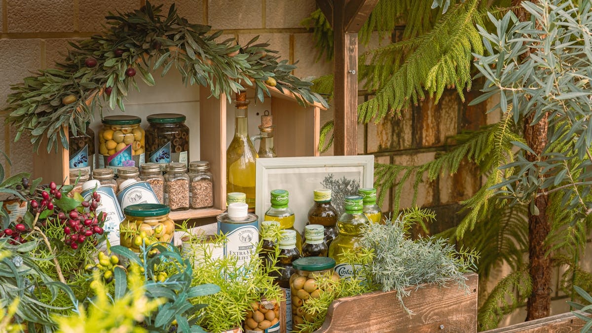 Charming outdoor display of olive oils and herbs, perfect for rustic decor enthusiasts.